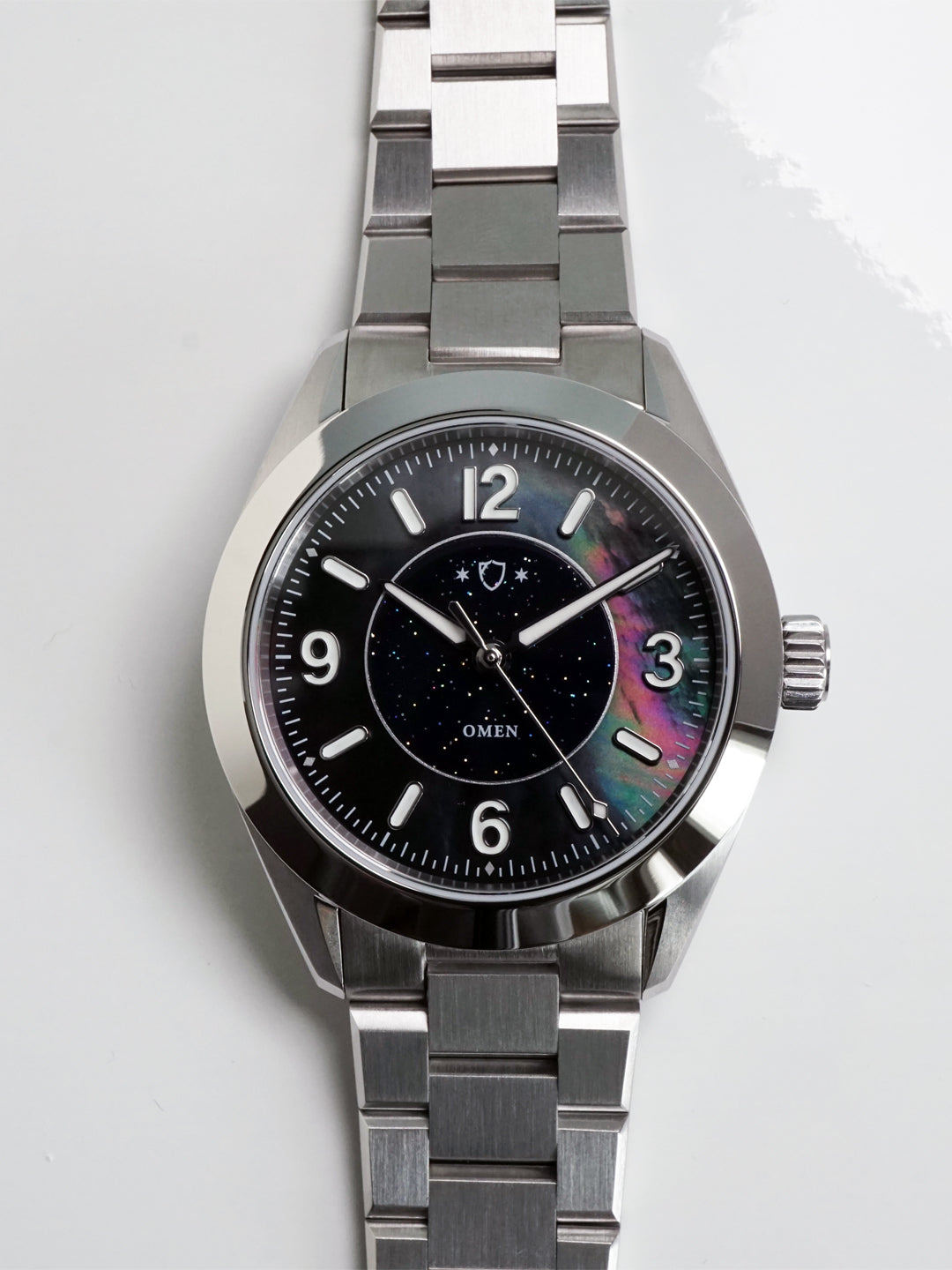 Silver watch with a black face on a white background