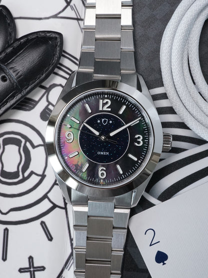 Silver watch with a colorful face on a patterned surface