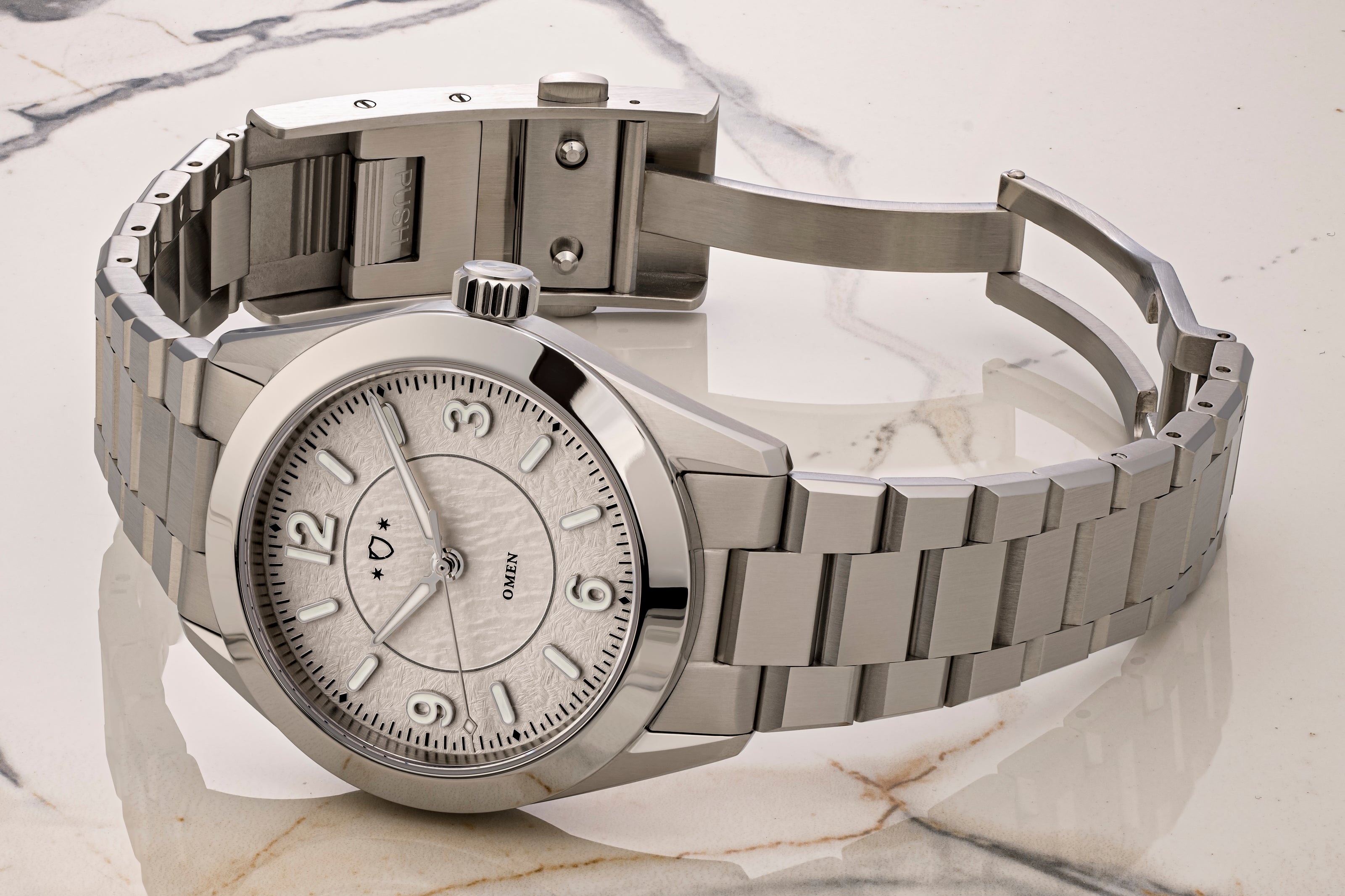 watch with a detailed face on a marble surface