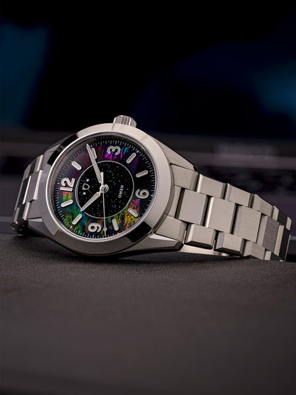 Silver watch with a colorful face on a dark background