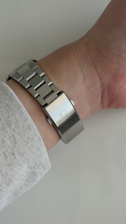 wrist roll of silver watch with white face