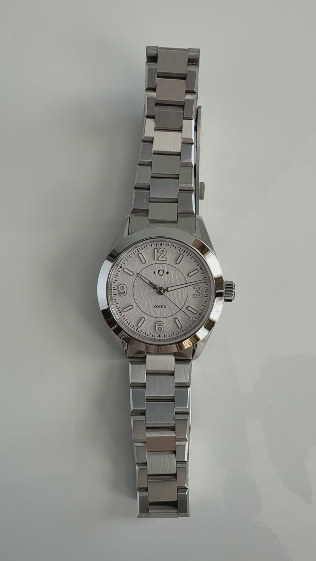 demonstration of silver watch with white face