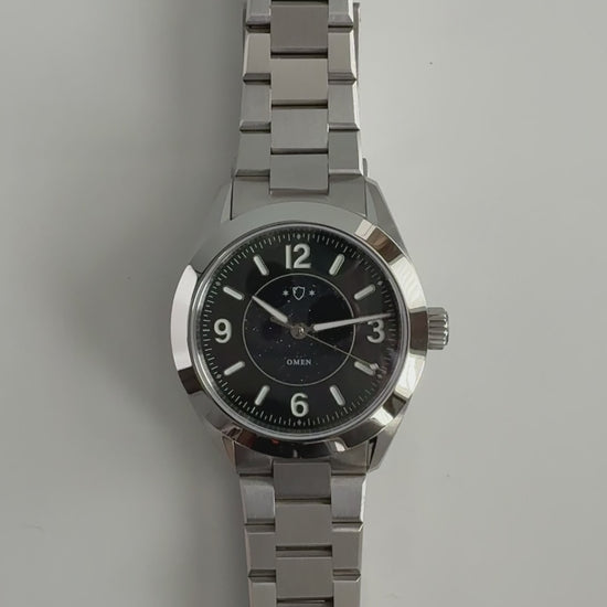 demonstration of silver watch with black face