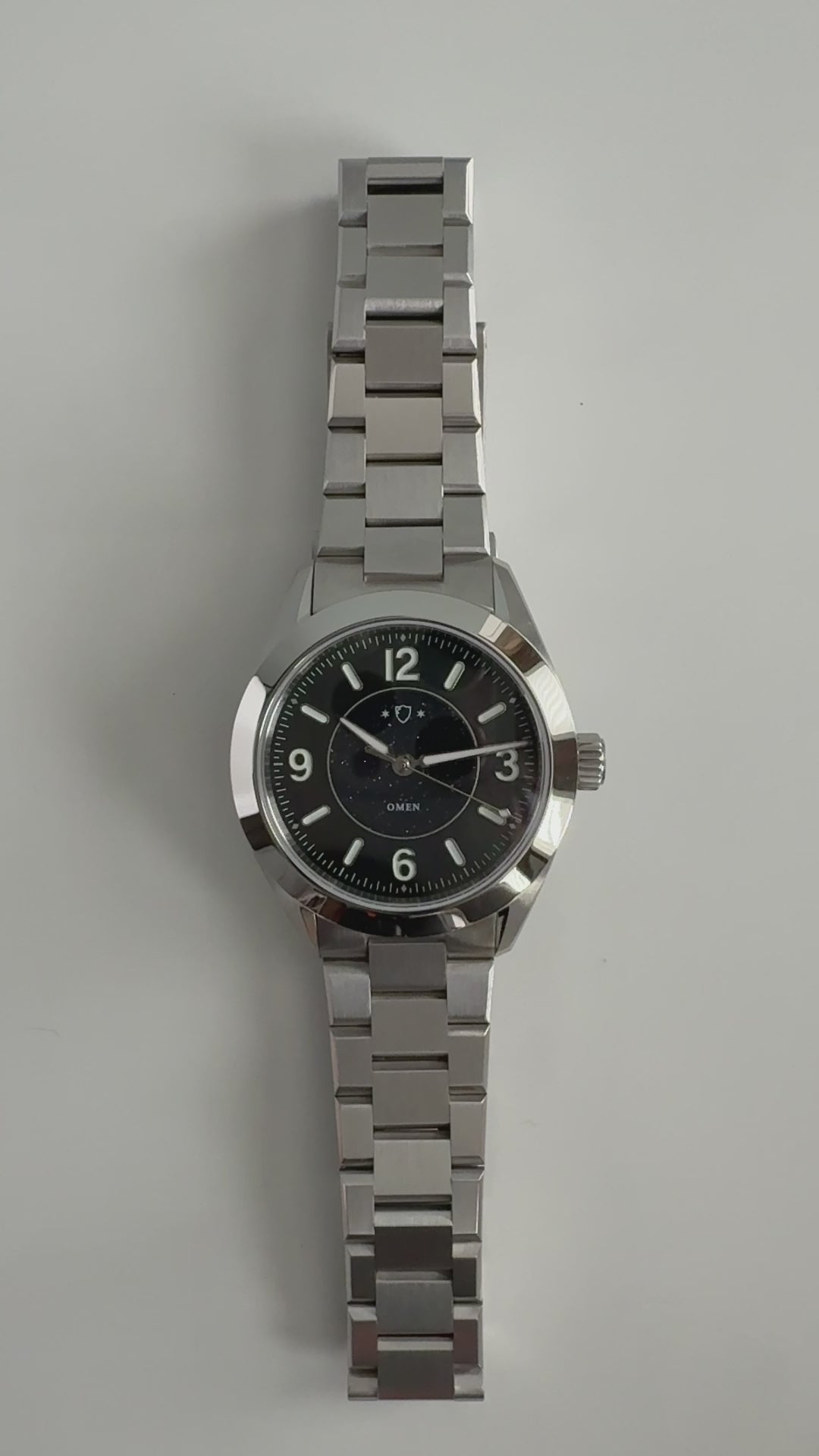 demonstration of silver watch with black face