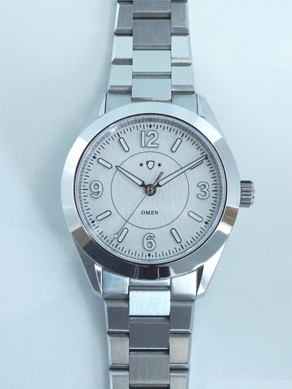 Silver watch with a white face on a light blue background